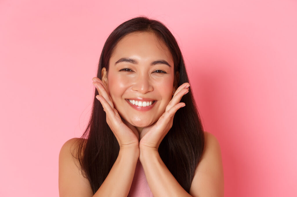 Young woman smiling with refreshed, glowing skin