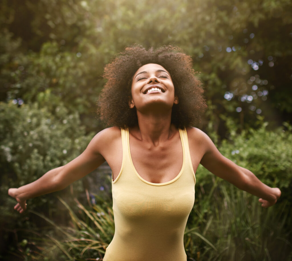 Energized young woman smiling outdoors. 