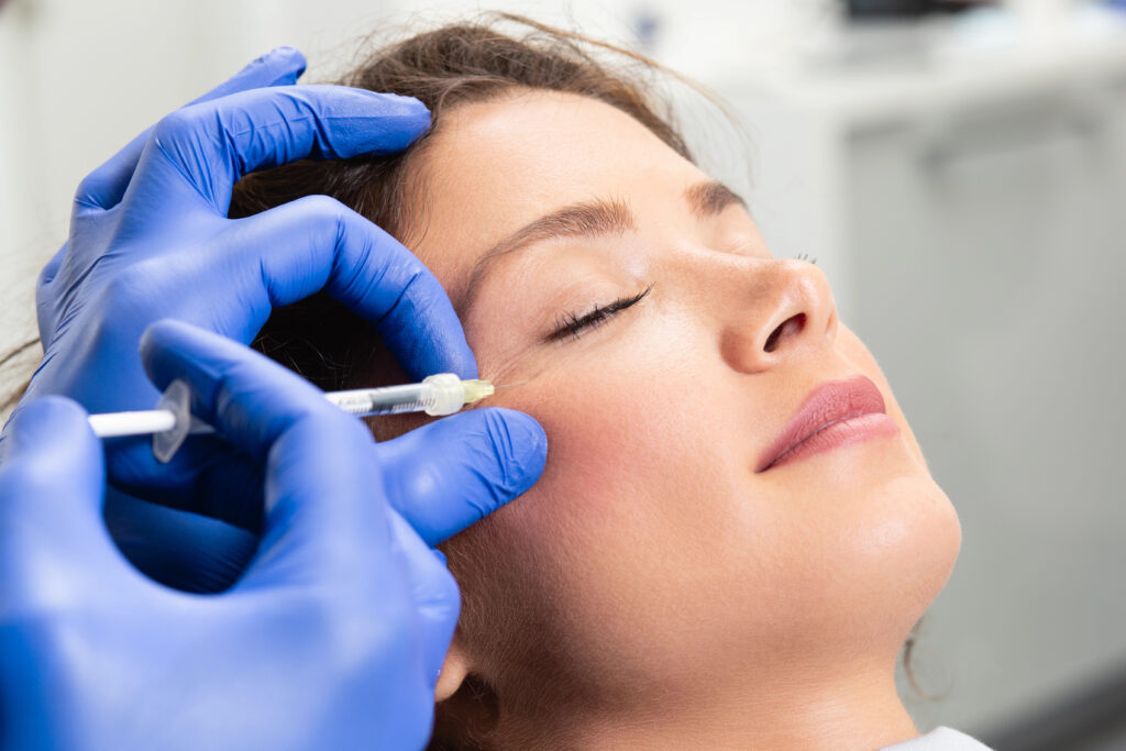 Young woman receiving Botox injections. 
